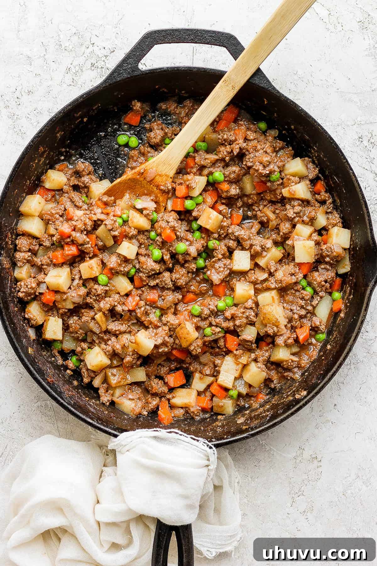 Classic Mexican Beef Hash 9 Finished Mexican picadillo in a cast iron skillet, garnished with fresh cilantro, ready to be served.