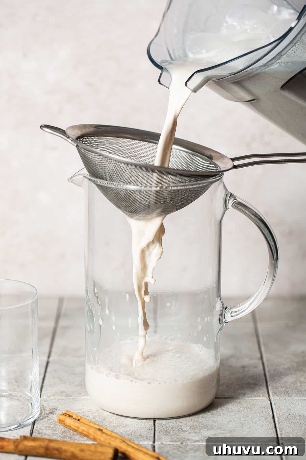 Straining blended mixture through a strainer