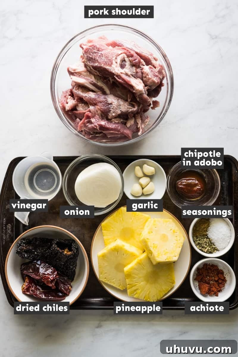 A vibrant selection of Tacos al Pastor ingredients laid out on a rustic wooden table.