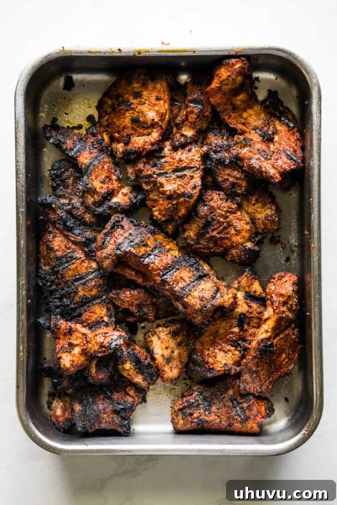 Perfectly grilled pork slices for Tacos al Pastor, showing crispy edges and juicy interiors.