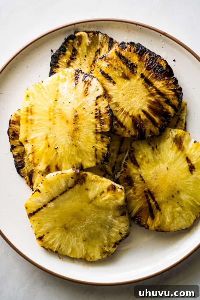 Grilled pineapple slices for Tacos al Pastor, featuring beautiful caramelized grill marks.
