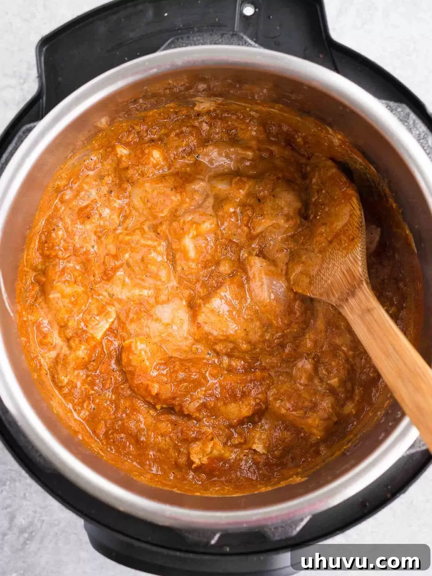 Adding chicken and tomato puree to the Instant Pot