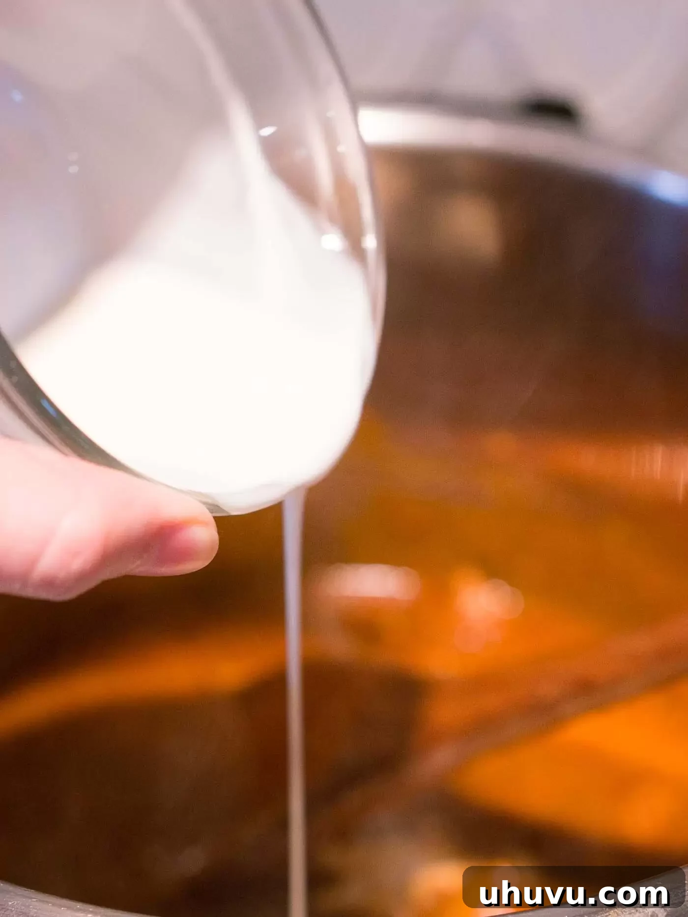 Adding heavy cream to finished chicken tikka masala