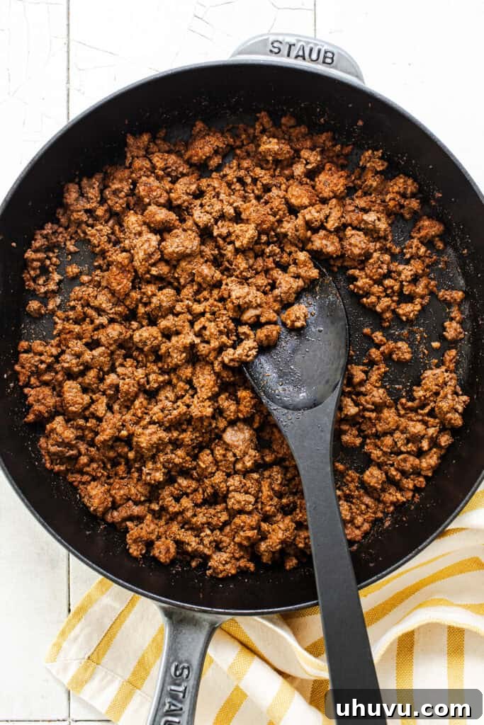 Seasoned ground beef for healthy taco bowls in a skillet