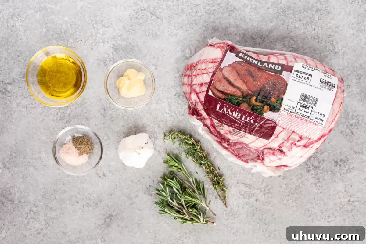 Ingredients for herb roasted leg of lamb including boneless lamb, garlic, rosemary, thyme, olive oil, salt, and pepper.