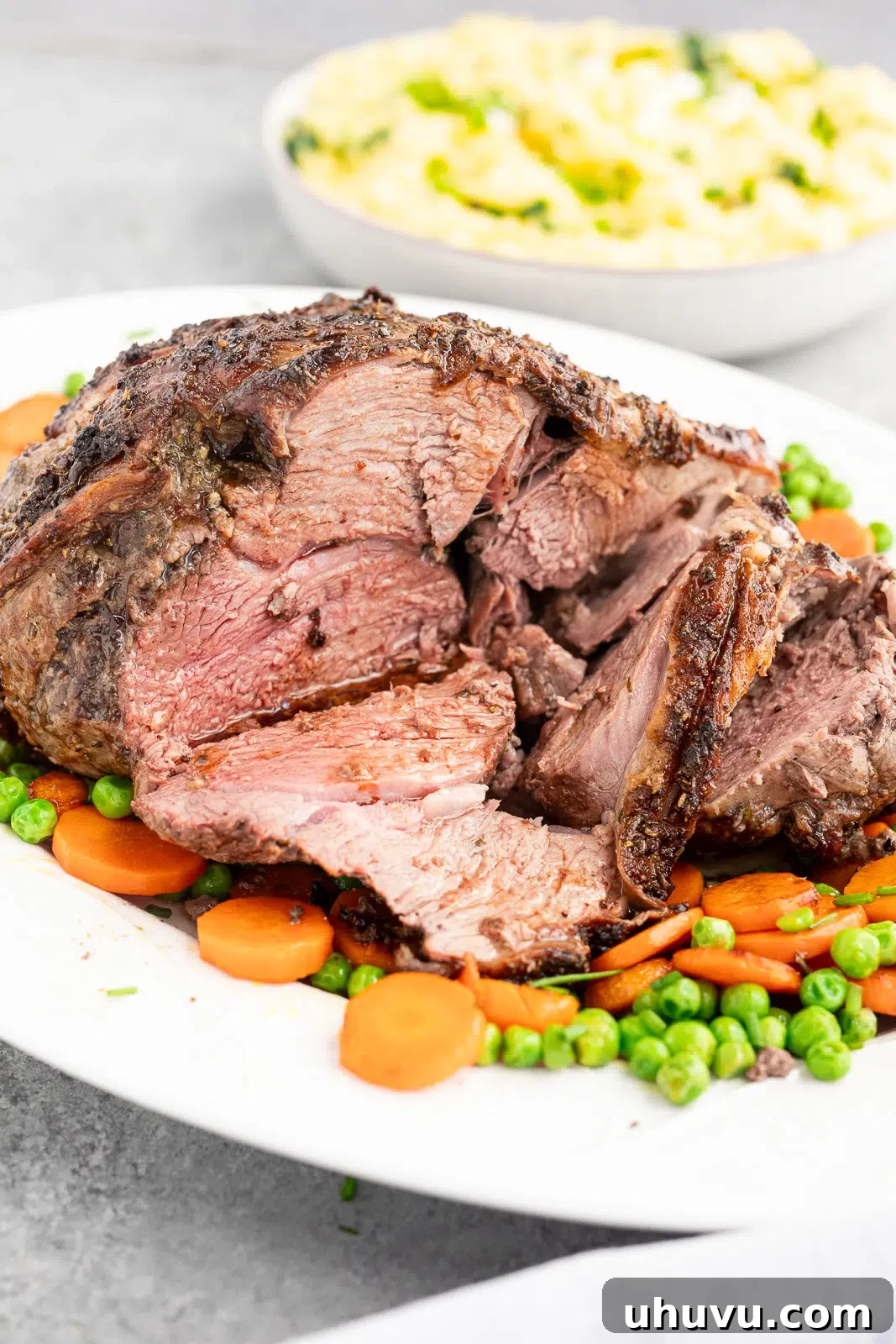 Juicy sliced roasted leg of lamb showing tender slightly pink center