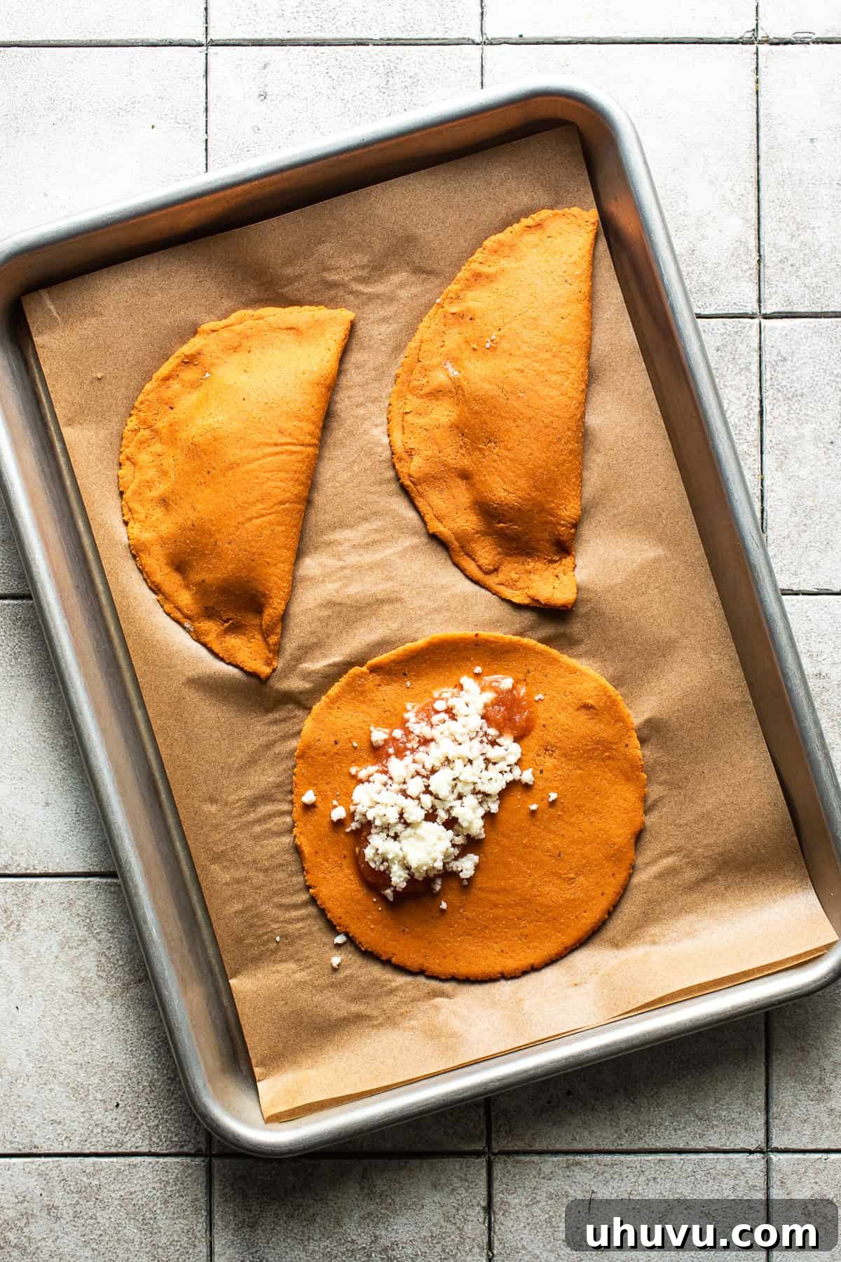 San Luis Potosí's Signature Enchiladas 6 The chile-infused masa dough for enchiladas potosinas with some fresh salsa and queso fresco on top before being folded over and fried.