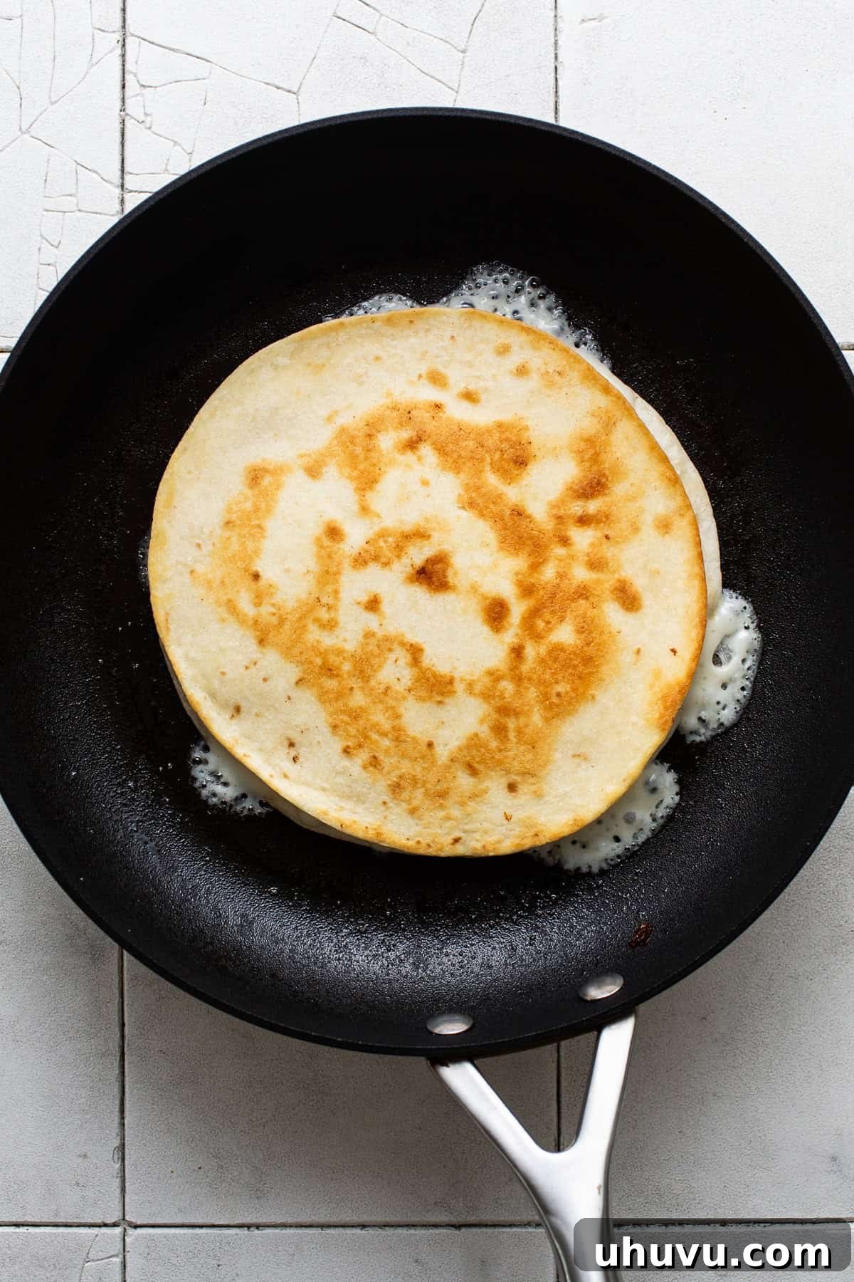 In Sync 6 A crispy golden sincronizada in a skillet ready to be sliced and served.