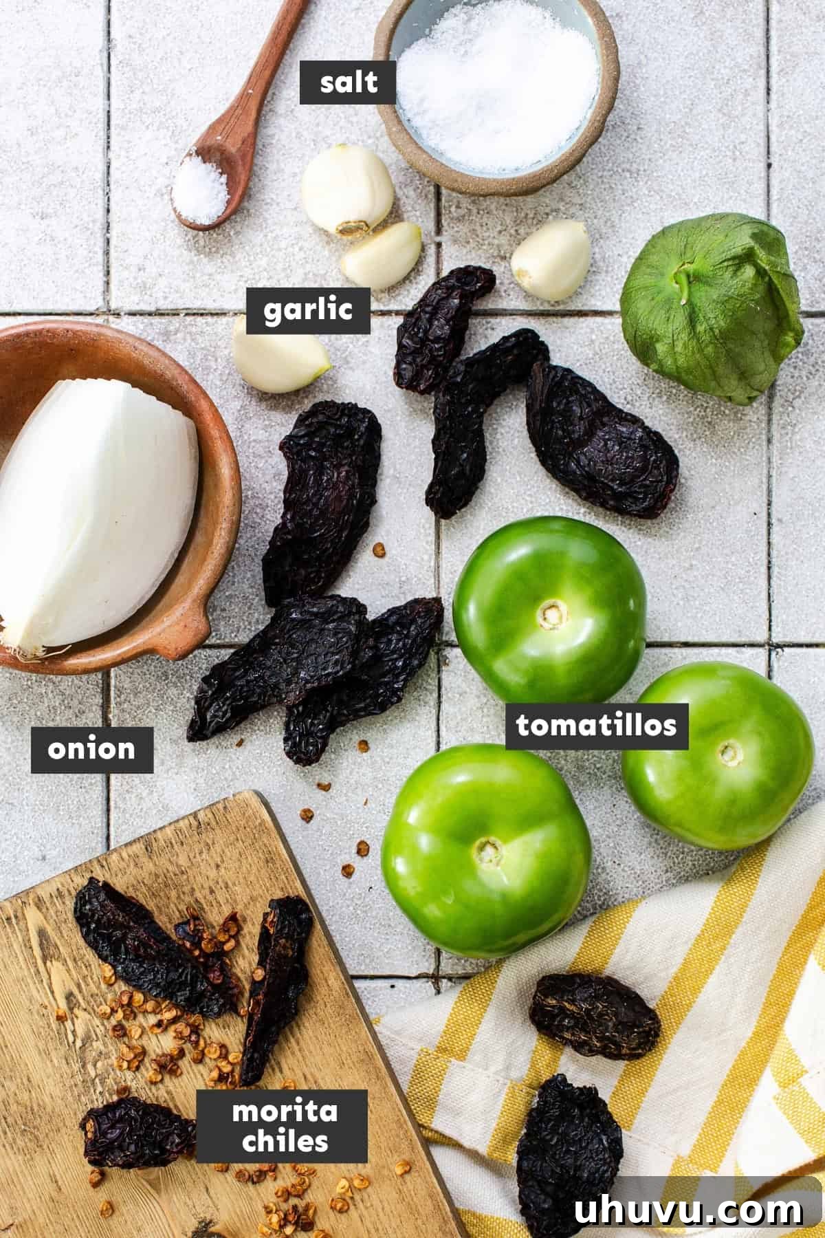 All the fresh and dried ingredients for making Salsa Morita laid out on a table.