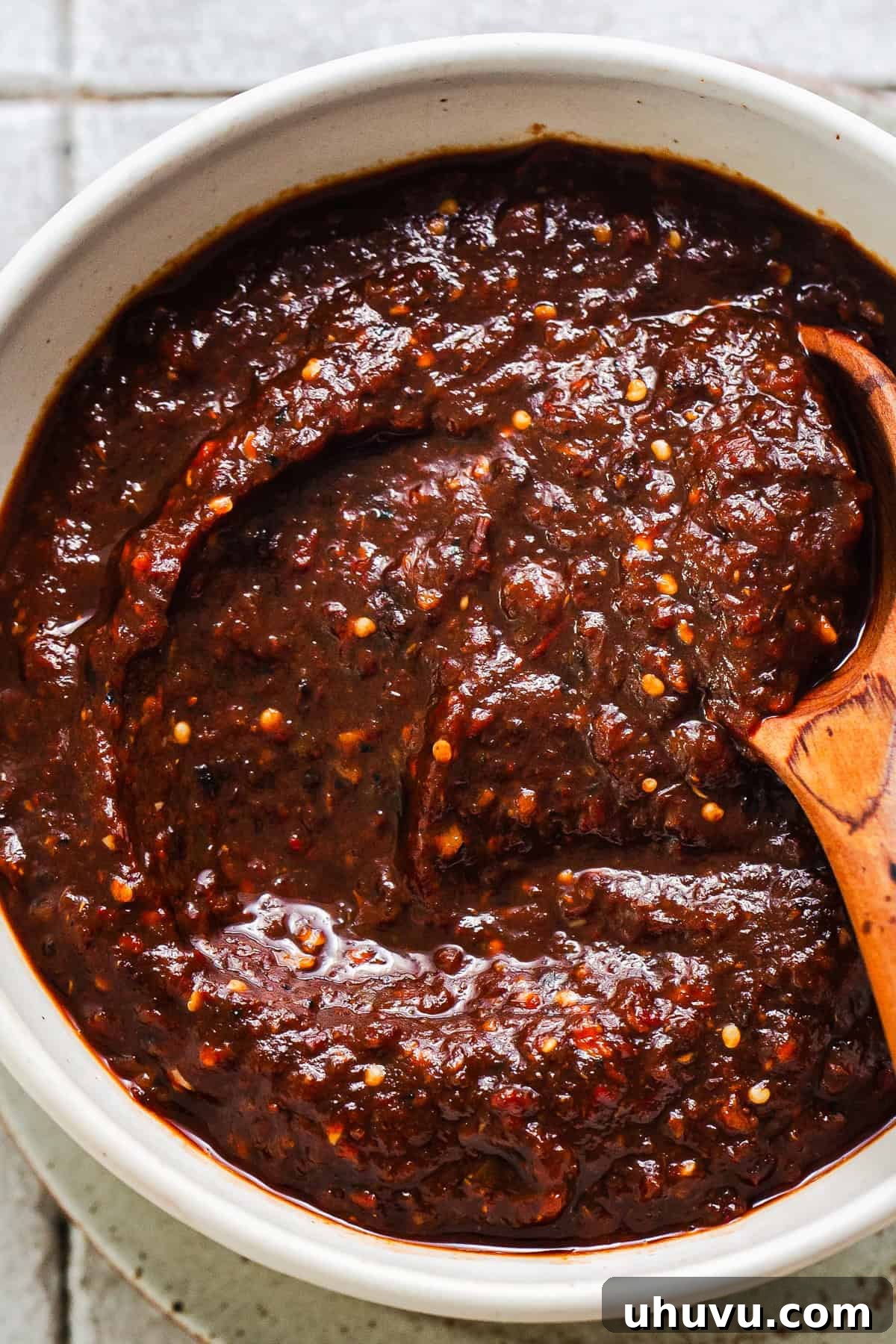 A close-up shot of the finished Salsa Morita poured into an earthenware bowl.