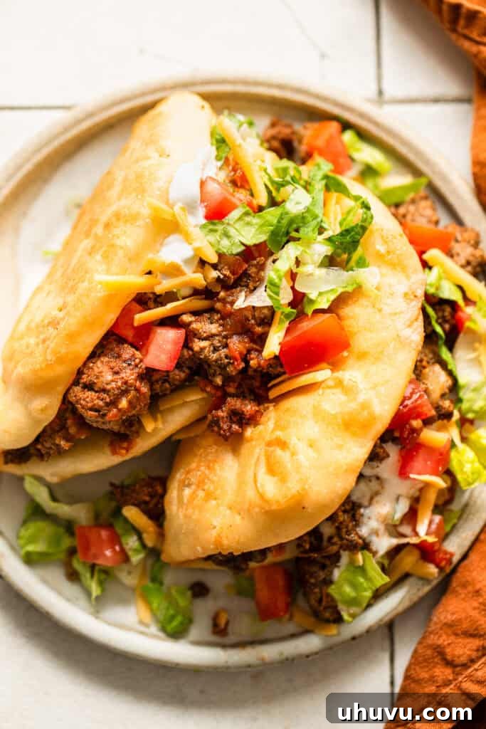 Crispy Homemade Chalupas Recipe 8 Homemade copycat Taco Bell chalupas on a plate ready to eat.